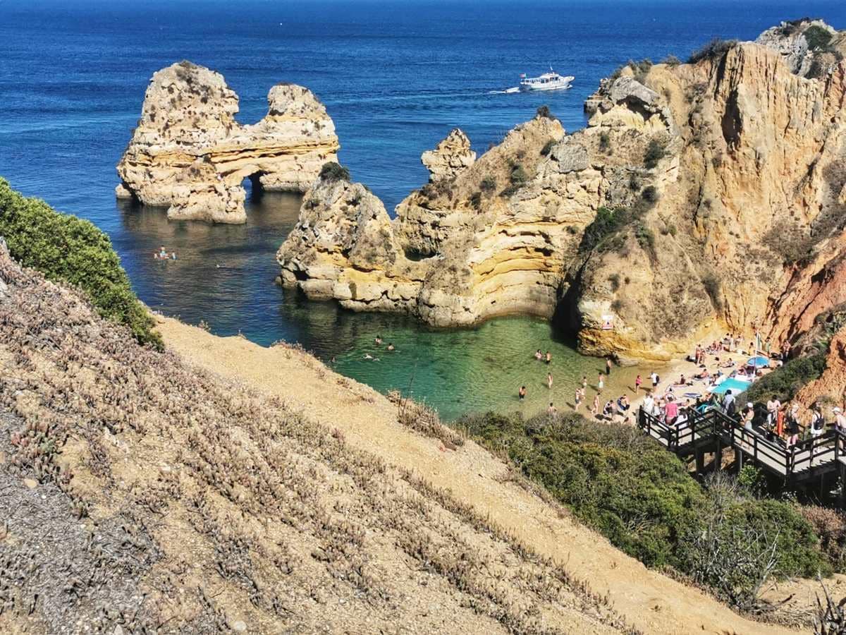 Beaches in Lagos famous Praia do Camilo view from the glass of Trilho dos Pescadores